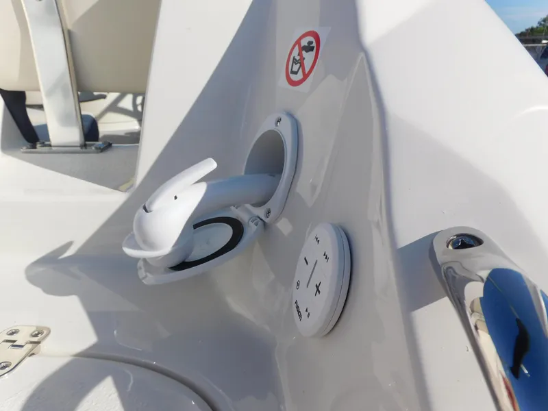 Slide: The Image of 2024 Stingray 211 DC boat control panel with cup holder and audio controls. - 23