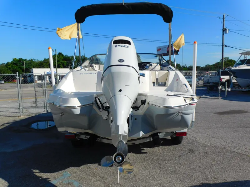 Slide: The Image of 2024 Stingray 211 DC boat with outboard motor, rear view. - 3