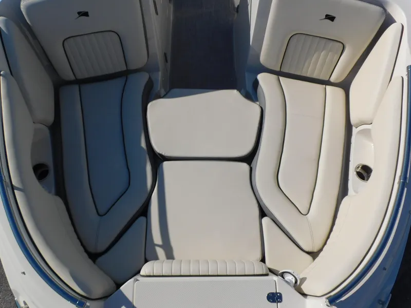 Slide: The Image of 2024 Stingray 211 DC boat interior with beige cushioned seating. - 5