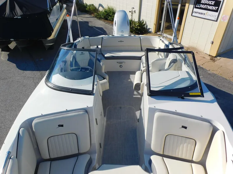 Slide: The Image of 2024 Stingray 211 DC boat interior with seating and windshield. - 6