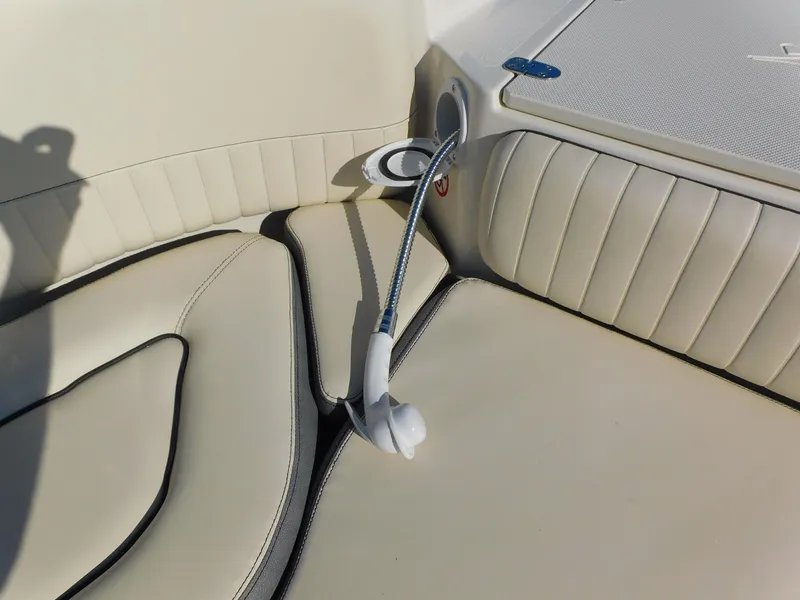 Slide: The Image of 2024 Stingray 211 DC boat interior with beige cushioned seating. - 7