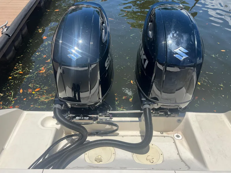 Slide: The Image of Twin outboard motors on a 1996 Pursuit 2470 CC boat. - 12