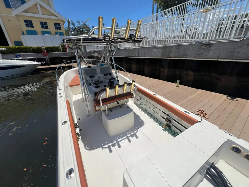Slide: The Image of 1996 Pursuit 2470 CC boat docked near a marina. - 13