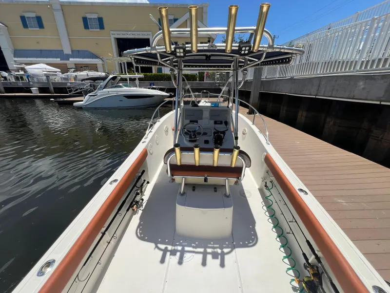 Slide: The Image of 1996 Pursuit 2470 CC boat docked at marina, center console view. - 14