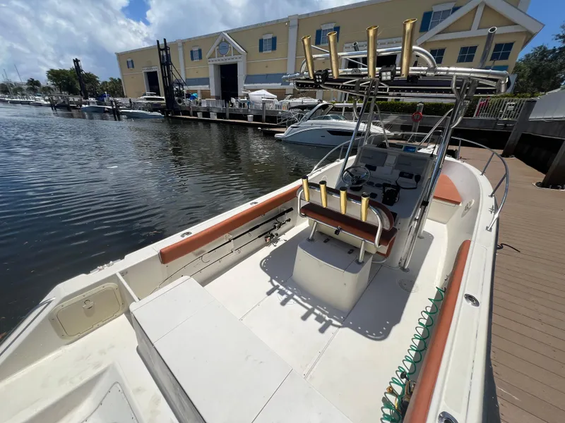 Slide: The Image of 1996 Pursuit 2470 CC boat docked at marina, ready for fishing. - 15