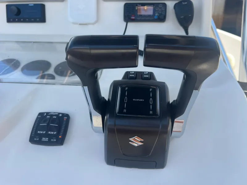 Slide: The Image of Dual throttle controls on a 1996 Pursuit 2470 CC boat dashboard. - 20