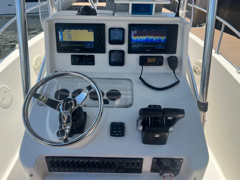Slide: The Image of 1996 Pursuit 2470 CC boat console with navigation and control systems. - 22
