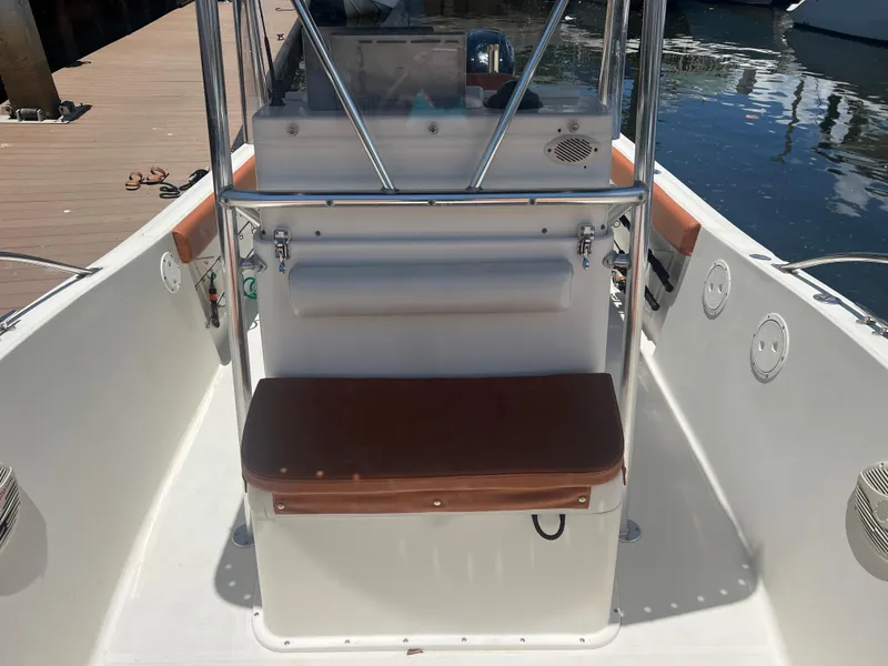 Slide: The Image of 1996 Pursuit 2470 CC boat interior with seating and console. - 24