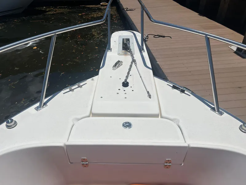 Slide: The Image of 1996 Pursuit 2470 CC boat bow with anchor chain and railings. - 29