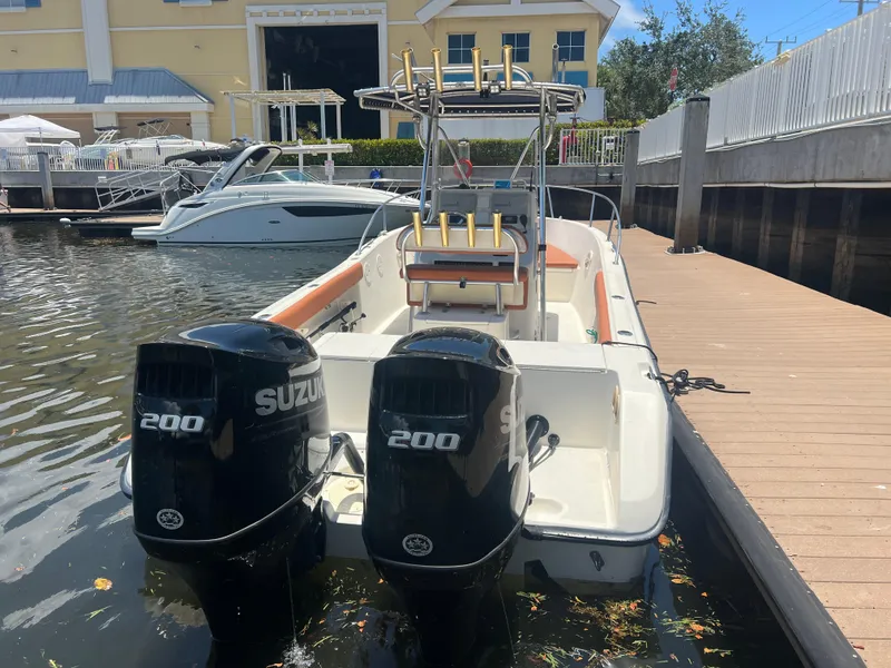 Slide: The Image of 1996 Pursuit 2470 CC boat with twin Suzuki 200 engines docked at marina. - 6