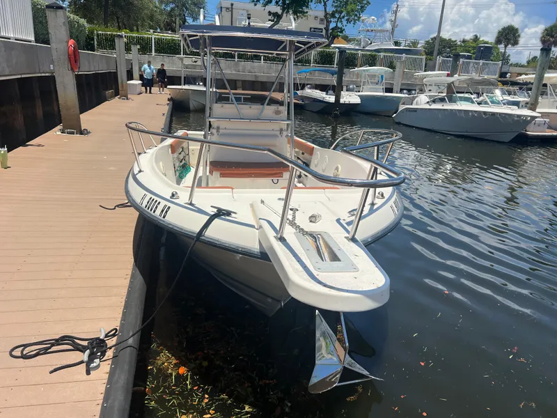 Slide: The Image of 1996 Pursuit 2470 CC boat docked at a marina on a sunny day. - 7