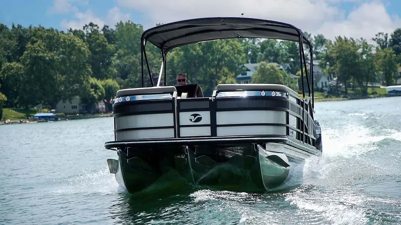 Slide: The Image of 2024 Vanderbilt 700 T pontoon boat cruising on a lake. - 1