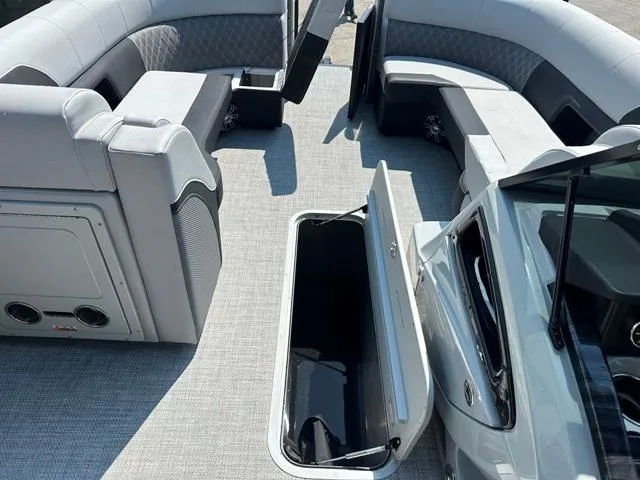 Slide: The Image of 2024 Vanderbilt 700 T boat interior with open storage compartment and cushioned seating. - 16