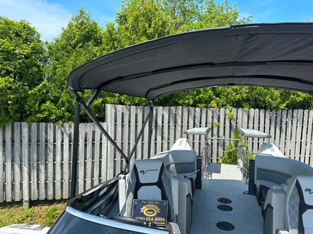 Slide: The Image of 2024 Vanderbilt 700 T boat with canopy, for sale sign, and seating area. - 22