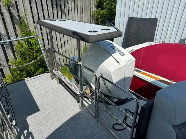 Slide: The Image of 2024 Vanderbilt 700 T boat with Evinrude outboard motor and fishing rod holders. - 30