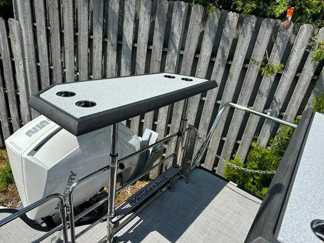 Slide: The Image of Vanderbilt 700 T 2024 boat with outboard motor and fishing rod holders. - 31