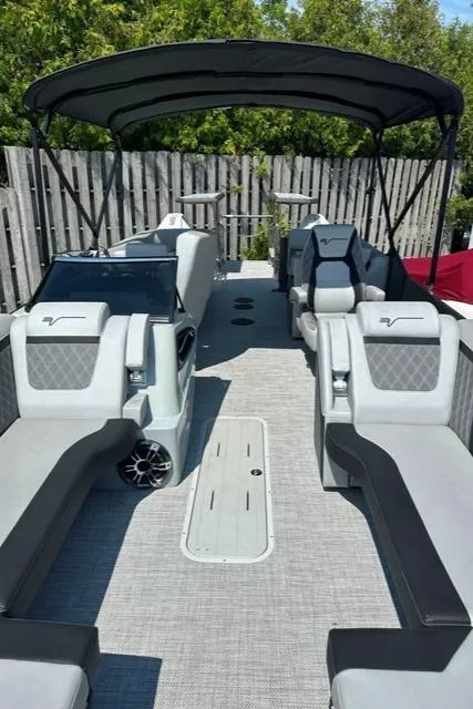 Slide: The Image of 2024 Vanderbilt 700 T luxury pontoon boat with spacious seating and canopy. - 8