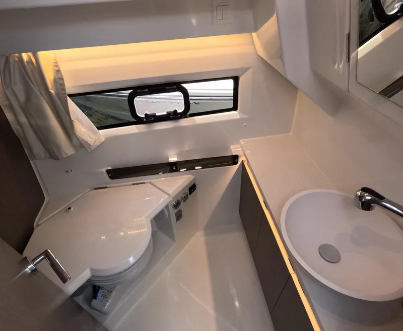 Slide: The Image of 2024 Jeanneau NC Weekender 895 Series 2 bathroom with modern fixtures and window. - 7