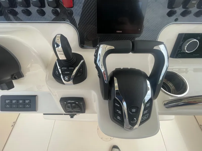 Slide: The Image of 2025 Grady-White Canyon 271 boat control panel with joystick and throttle. - 13
