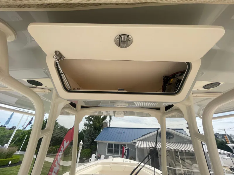 Slide: The Image of 2025 Grady-White Canyon 271 boat storage compartment open. - 17