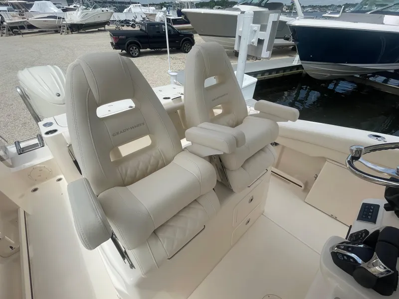 Slide: The Image of 2025 Grady-White Canyon 271 boat with luxurious seating at a marina. - 18