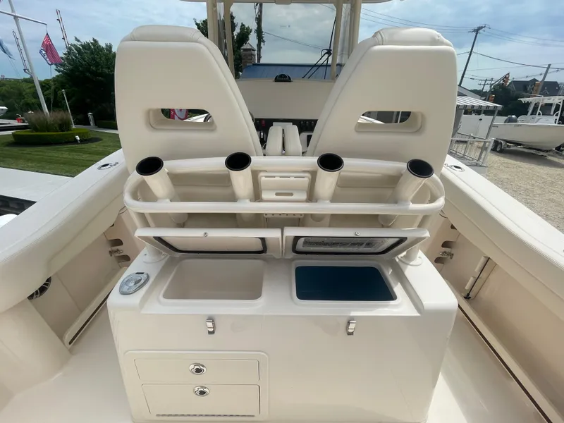 Slide: The Image of 2025 Grady-White Canyon 271 boat interior with rod holders and storage compartments. - 19