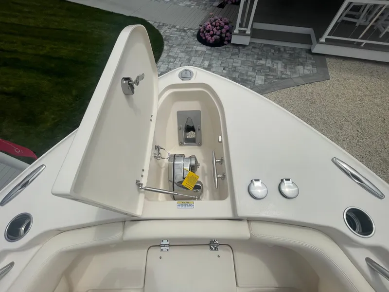 Slide: The Image of 2025 Grady-White Canyon 271 boat bow with anchor storage compartment open. - 2