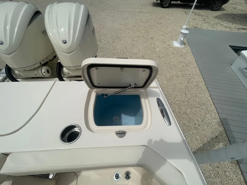 Slide: The Image of 2025 Grady-White Canyon 271 boat with open storage compartment and twin engines. - 22