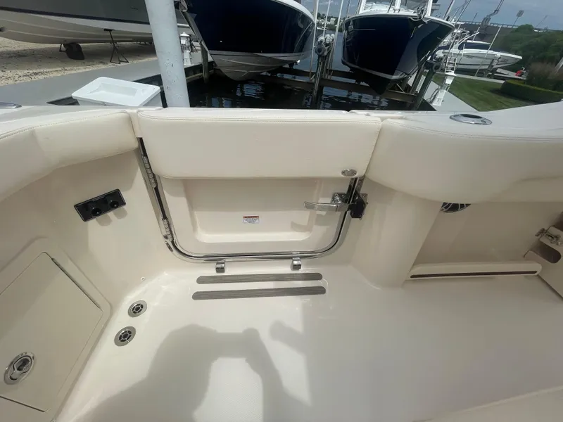 Slide: The Image of Grady-White Canyon 271 2025 boat interior, rear view with open transom door. - 23