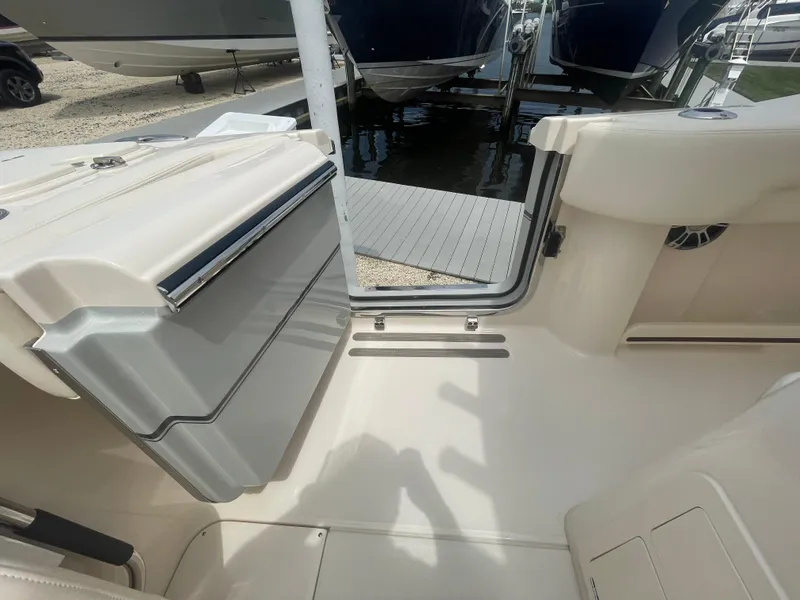 Slide: The Image of 2025 Grady-White Canyon 271 boat interior with open storage compartment. - 24