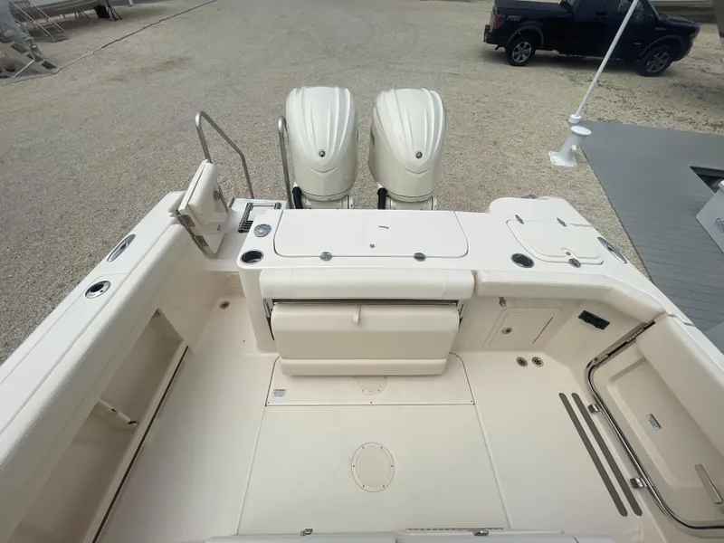 Slide: The Image of 2025 Grady-White Canyon 271 boat deck with twin outboard engines. - 25