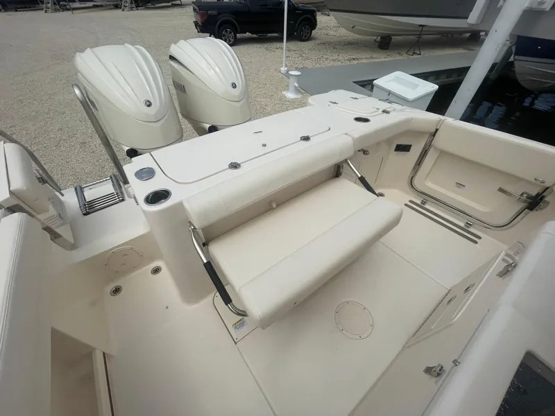 Slide: The Image of 2025 Grady-White Canyon 271 boat with dual outboard engines and spacious seating. - 26