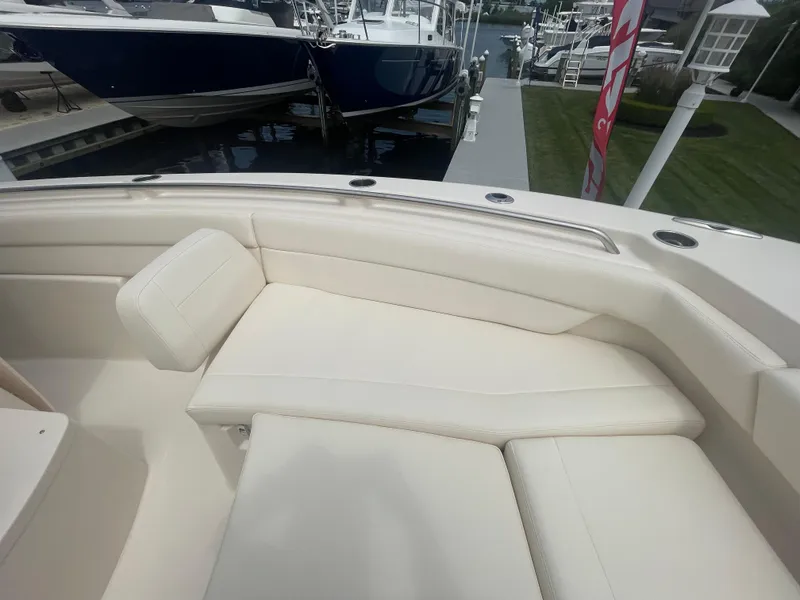 Slide: The Image of 2025 Grady-White Canyon 271 boat with white cushioned seating area. - 4