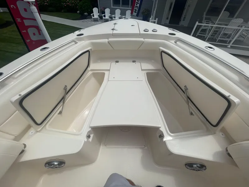 Slide: The Image of 2025 Grady-White Canyon 271 boat interior with open storage compartments. - 6