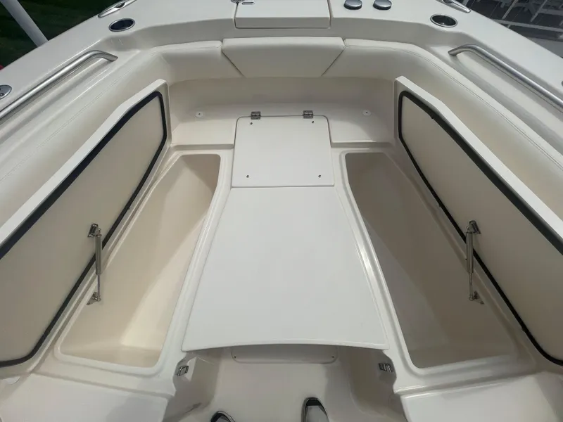 Slide: The Image of 2025 Grady-White Canyon 271 boat interior with open storage compartments. - 7