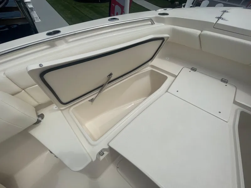 Slide: The Image of 2025 Grady-White Canyon 271 boat storage compartments and seating area. - 8
