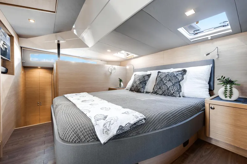 Slide: The Image of Luxurious bedroom interior of 2024 Aquila 44 Yacht with modern decor and natural light. - 1