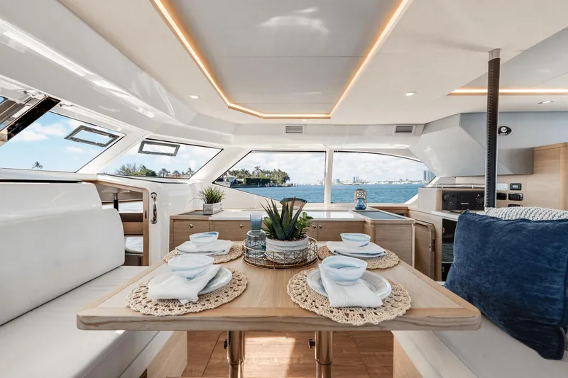 Slide: The Image of Interior of 2024 Aquila 44 Yacht with dining table set for four, ocean view. - 14