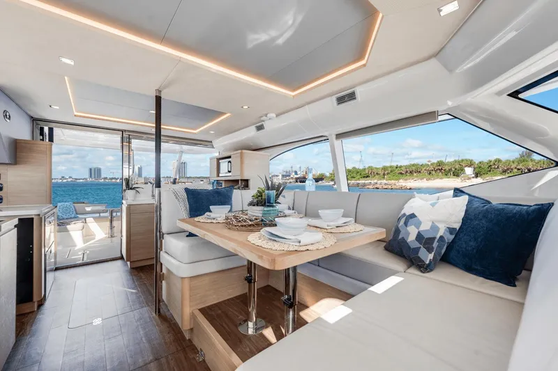 Slide: The Image of Interior of 2024 Aquila 44 Yacht with dining area and ocean view. - 15