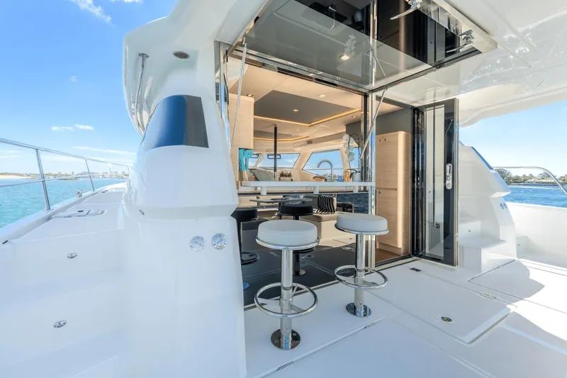 Slide: The Image of 2024 Aquila 44 Yacht interior with bar stools and ocean view. - 22
