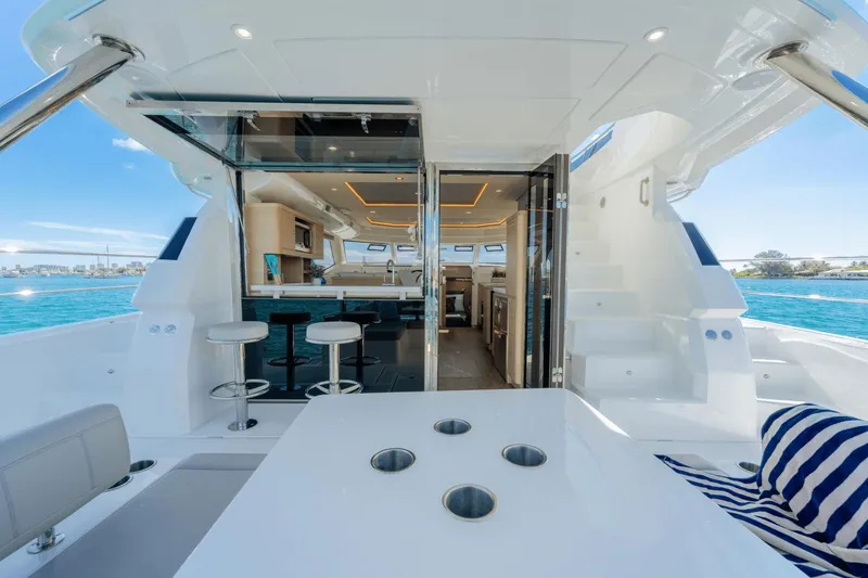 Slide: The Image of Aquila 44 Yacht 2024 interior with bar stools and ocean view. - 26