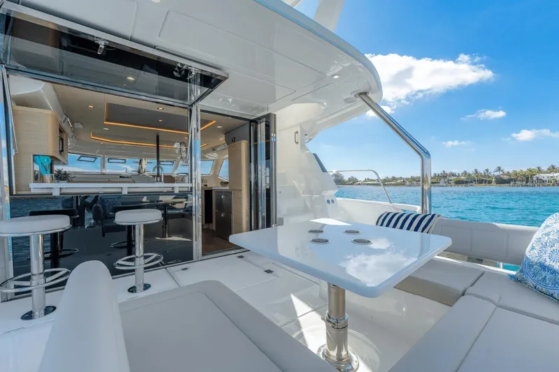 Slide: The Image of 2024 Aquila 44 Yacht interior and exterior seating area with ocean view. - 29