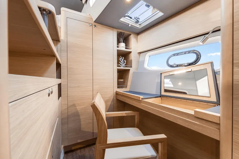 Slide: The Image of 2024 Aquila 44 Yacht interior cabin with wooden furniture and skylight. - 3