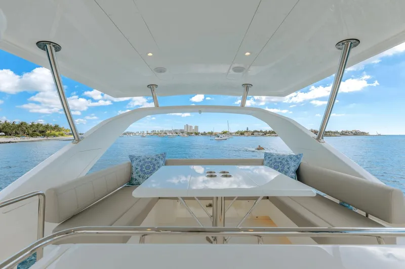 Slide: The Image of Aquila 44 Yacht 2024 interior with ocean view, featuring a spacious seating area and table. - 32