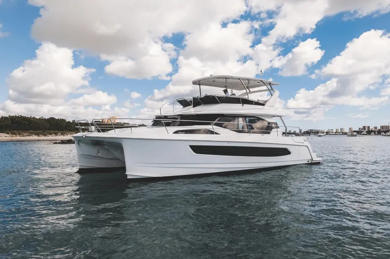 Slide: The Image of 2024 Aquila 44 Yacht on calm waters under a partly cloudy sky. - 36