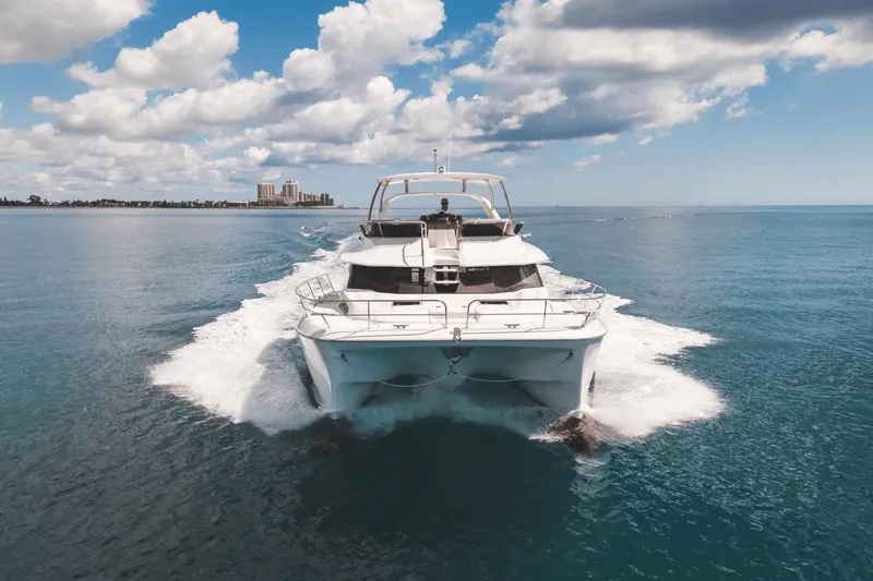 Slide: The Image of 2024 Aquila 44 Yacht cruising on open water under a partly cloudy sky. - 43