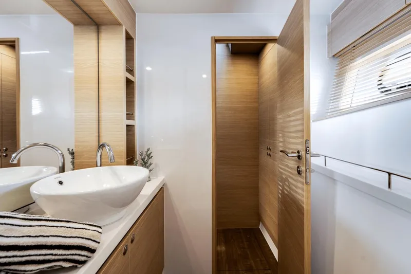 Slide: The Image of Modern bathroom interior on 2024 Aquila 44 Yacht with sleek sink and wooden accents. - 7
