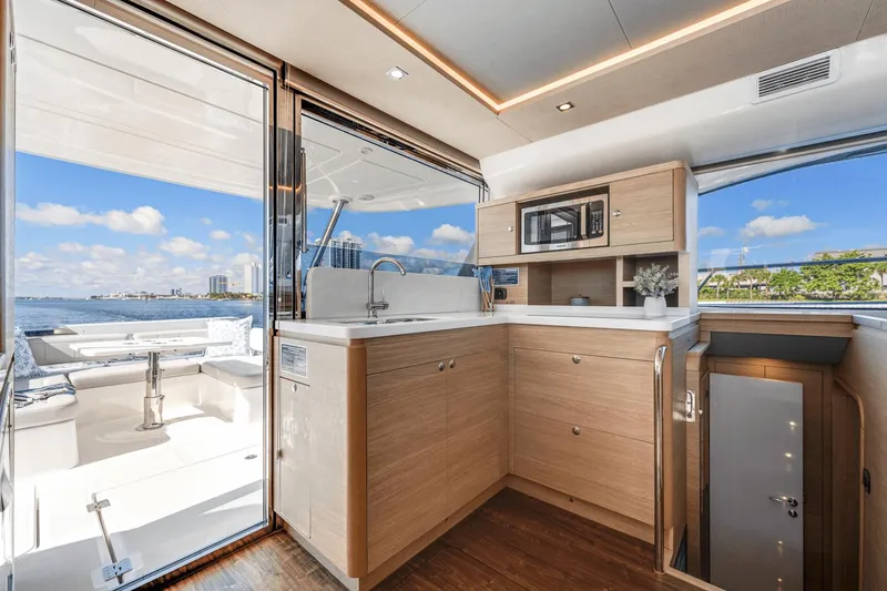 Slide: The Image of Interior of 2024 Aquila 44 Yacht with modern kitchen and scenic ocean view. - 9