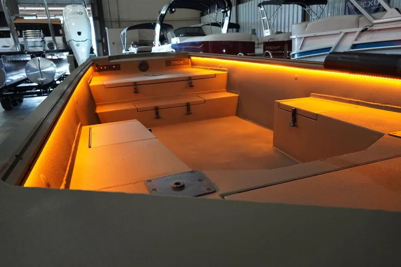 Slide: The Image of 2024 Thor Lake Hammer 1754 boat interior with ambient orange lighting. - 2