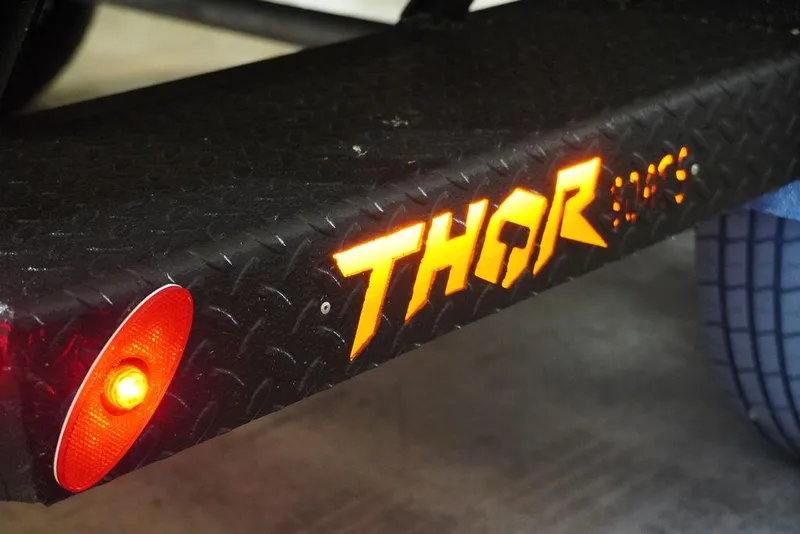 Slide: The Image of Close-up of 2024 Thor Lake Hammer 1754 trailer with illuminated logo and light. - 3